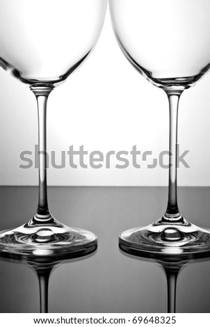 Two empty glasses on a black glass surface
