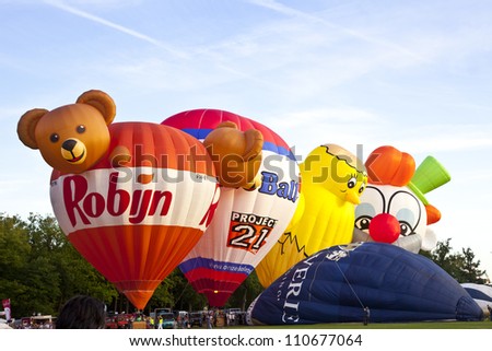 BARNEVELD, THE NETHERLANDS - AUGUST 17: Colorful air balloons taking off at international balloon festival Ballonfiesta on August 17,2012 in Barneveld, The Netherlands