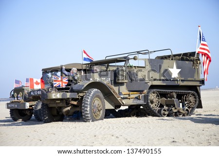 IJMUIDEN, THE NETHERLANDS-MAY 5 2013: Army trucks of organization Kelly's Heroes riding on beach on May 5,2013 in IJmuiden, The Netherlands. Simulate arrival of allies on liberation Second World War