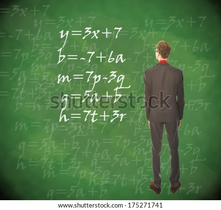 Young student looking at chalkboard with mathematics
