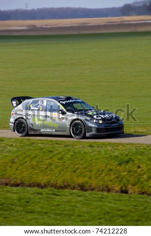EMMELOORD, THE NETHERLANDS - MARCH 19. Rally car racing at  Dutch championship with driver Jeroen Swaanen, Co-driver Robin Buysmans, Subaru S 14 on March 19, 2011 in Emmeloord, The Netherlands.