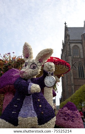 HAARLEM, THE NETHERLANDS - APRIL 17: Alice in Wonderland with flowers at flower parade on April 17 2011 in Haarlem, The Netherlands. The  flower parade is a huge event with one million visitors.
