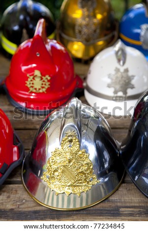 Several old fireman helmets in row