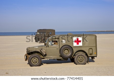 IJMUIDEN, THE NETHERLANDS-MAY 5: Kelly\'s Heroes medical army vehicle riding on beach on May 5,2011 in IJmuiden, The Netherlands. Kelly\'s Heroes celebrates the liberation of The Netherlands in 1945