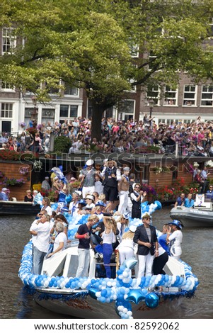 AMSTERDAM - AUGUST 6: People greeting from a boat at Canal Parade at Gay Pride weekend in Amsterdam on August 6, 2011. Gay Pride celebrates equality for gay,lesbian and transgender communities