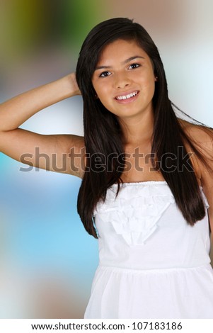 Happy teen girl smiling while standing outside