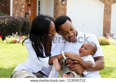 African American family together outside their home