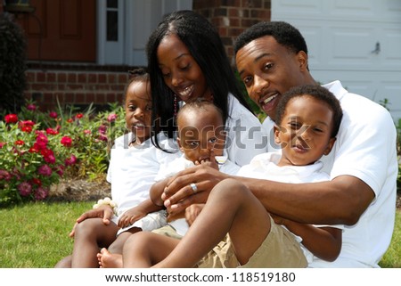African American family together outside their home