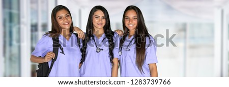 Three happy hispanic nursing students at school
