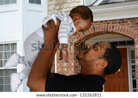 Father and his son playing outside in their yard