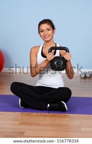 Teen girl working out in the gym