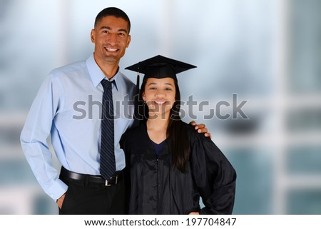 Student graduating standing by her teacher at school