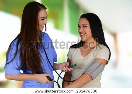 Female nurse working at her office with a patient