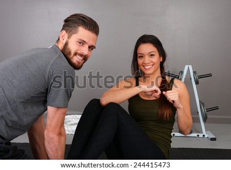 Woman working out at the gym with a personal trainer