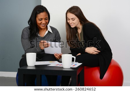 Businesswomen working on a project while in an office