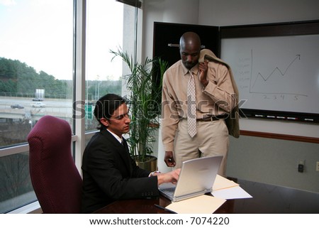 Businessmen working in an office dressed in a suit