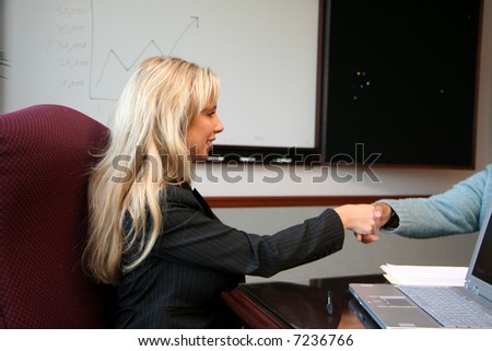 Young caucasian businesswoman with coworkers in an office setting