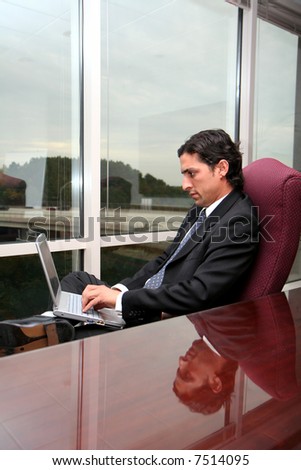 Businessman working in an office dressed in a suit