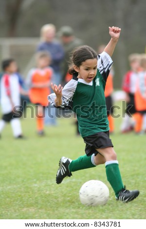 A young girl playing in a soccer league