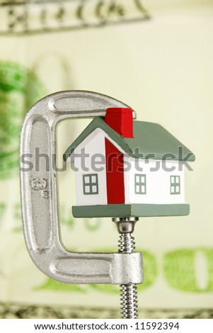 Grip holding a house portraying the housing market