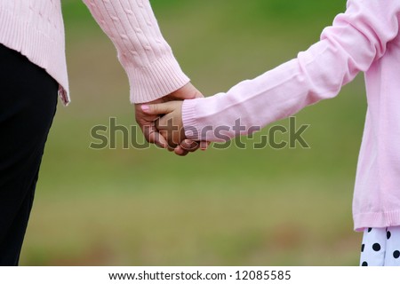 stock photo : Mother and daughter holding hands while walking together