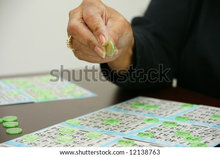 People playing bingo with chips and cards