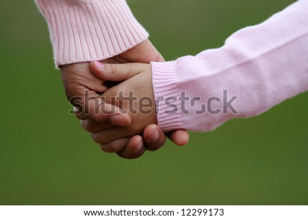 stock photo : Mother and daughter holding hands while walking together