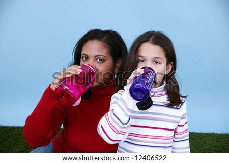 Family drinking from a bottle of water