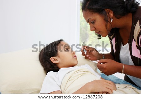 Child laying sick in bed at home