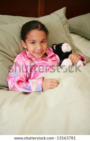 Girl laying in her bed ready to go to sleep