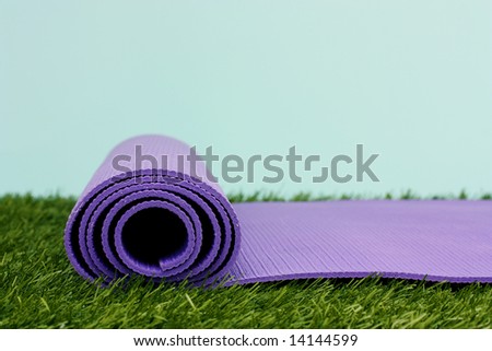 Purple Yoga Exercise Mat On Green Grass