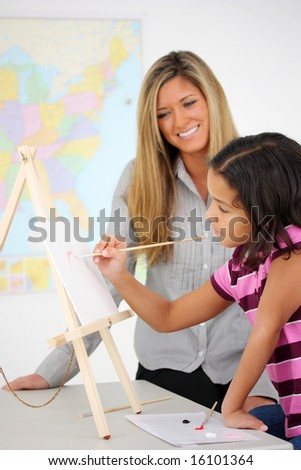 Teacher and Art Student In A Classroom At School