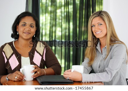 Two Friends Sitting At A Table Together