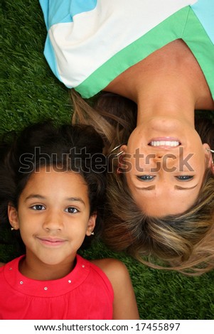 Family Laying Together Outside In The Grass