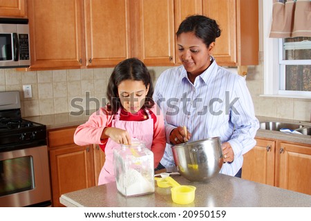 Girl and mother cooking in the kitchen
