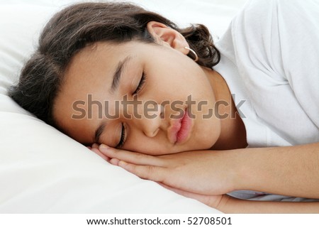 Girl sleeping on a pillow in white