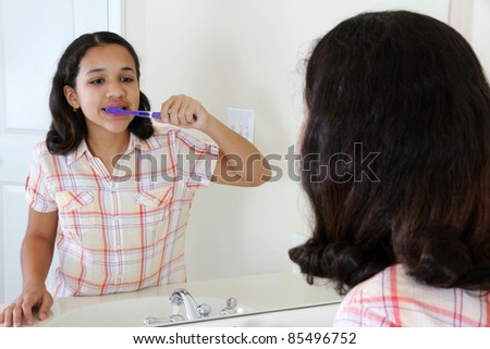 Person looking into a mirror brushing their teeth