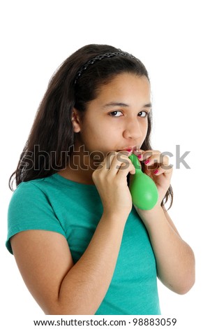 Teen Girl Blowing Up a Balloon in Studio