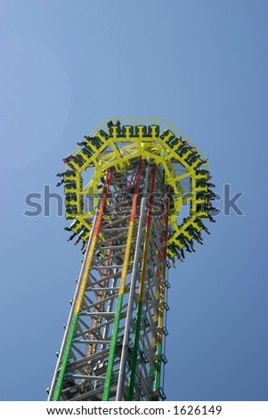 Free Fall Tower on a carnival area in bright sunlight