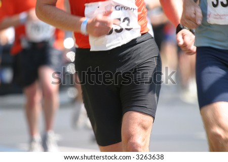 Detail of a marathon runner in full action