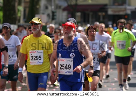 Two senior marathon runners trying to keep the pace during the international city marathon in Dusseldorf, Germany