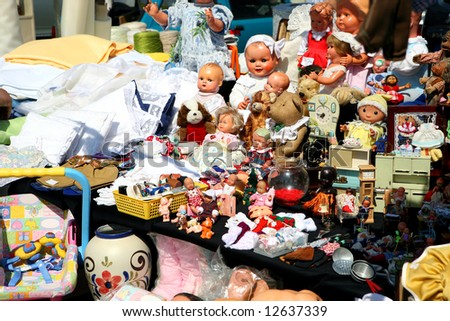 flea market booth with a huge variety of toys and dolls
