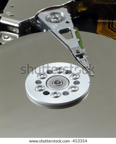 Exposed platter and heads of hard drive close up