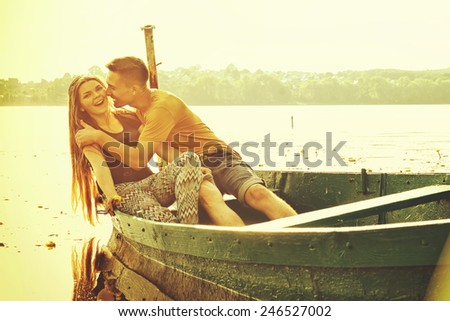 Couple kissing happiness fun. Girl and boy embracing laughing on date.Young couple in love outdoor. Man and woman in the boat on lake.