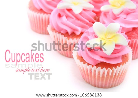 Pink Cupcake with frangipani on top isolated on white