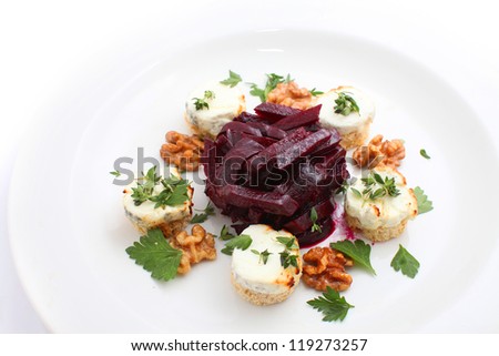 appetizer salad of beets and goat cheese isolated on white