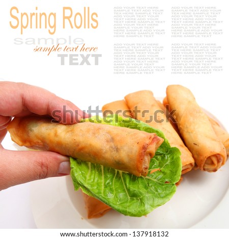 Spring rolls picked up with hand isolated on white