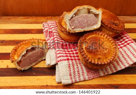 Cut Pork Pies on wooden background