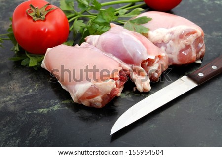 Fresh skinless chicken thighs on marble stone