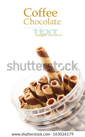 Striped wafer rolls filled with chocolate in the plastic bucket isolated on white